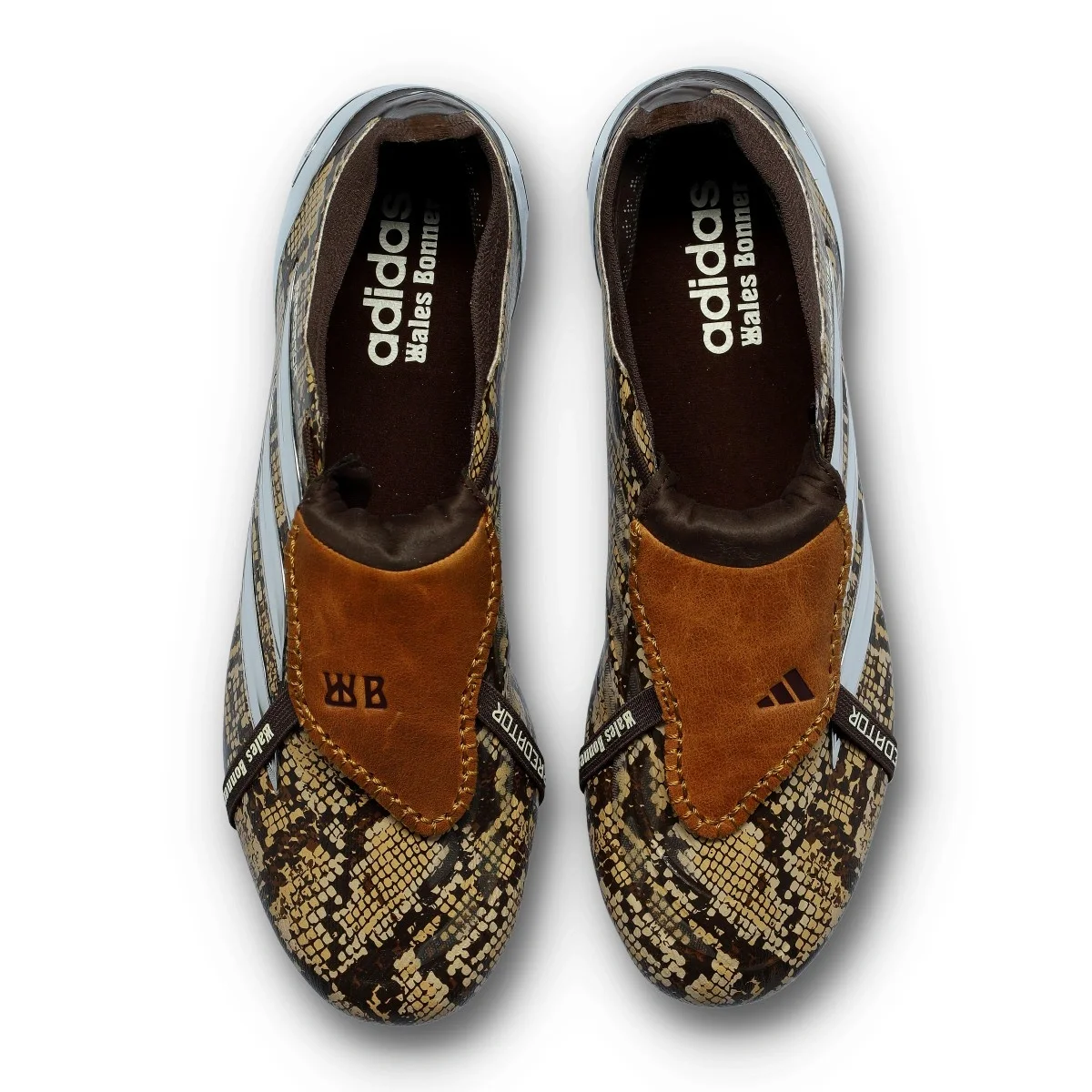 Both adidas Predator Elite Fold-Over Tongue x Wales Bonner boots viewed from above, in brown and tan snakeskin print with pale blue trim, “adidas” and “Wales Bonner” on the insoles and tan leather tongues with embossed “WB” stamps