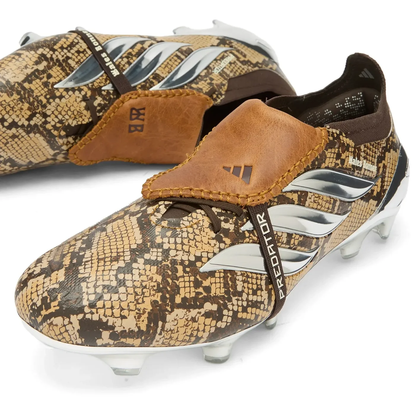 Two adidas Predator Elite Fold-Over Tongue x Wales Bonner boots in snakeskin print, showing the chrome mirrored Three Stripes, soleplate and “PREDATOR” and “Wales Bonner” printed tongue strap