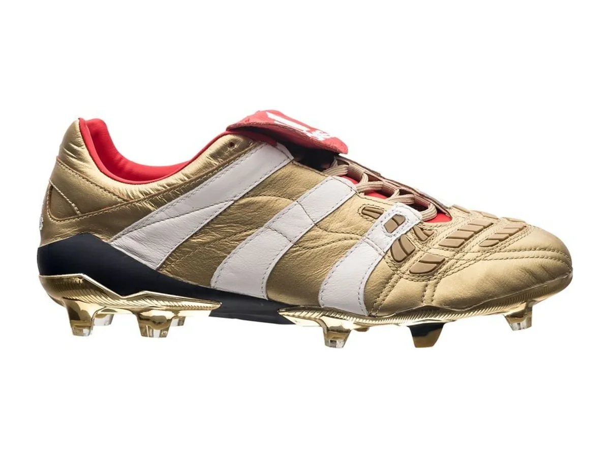 Zinedine Zidane's gold adidas Predator Accelerator from the 2019 25 Years of Predator pack, with white stripes and a red fold-over tongue